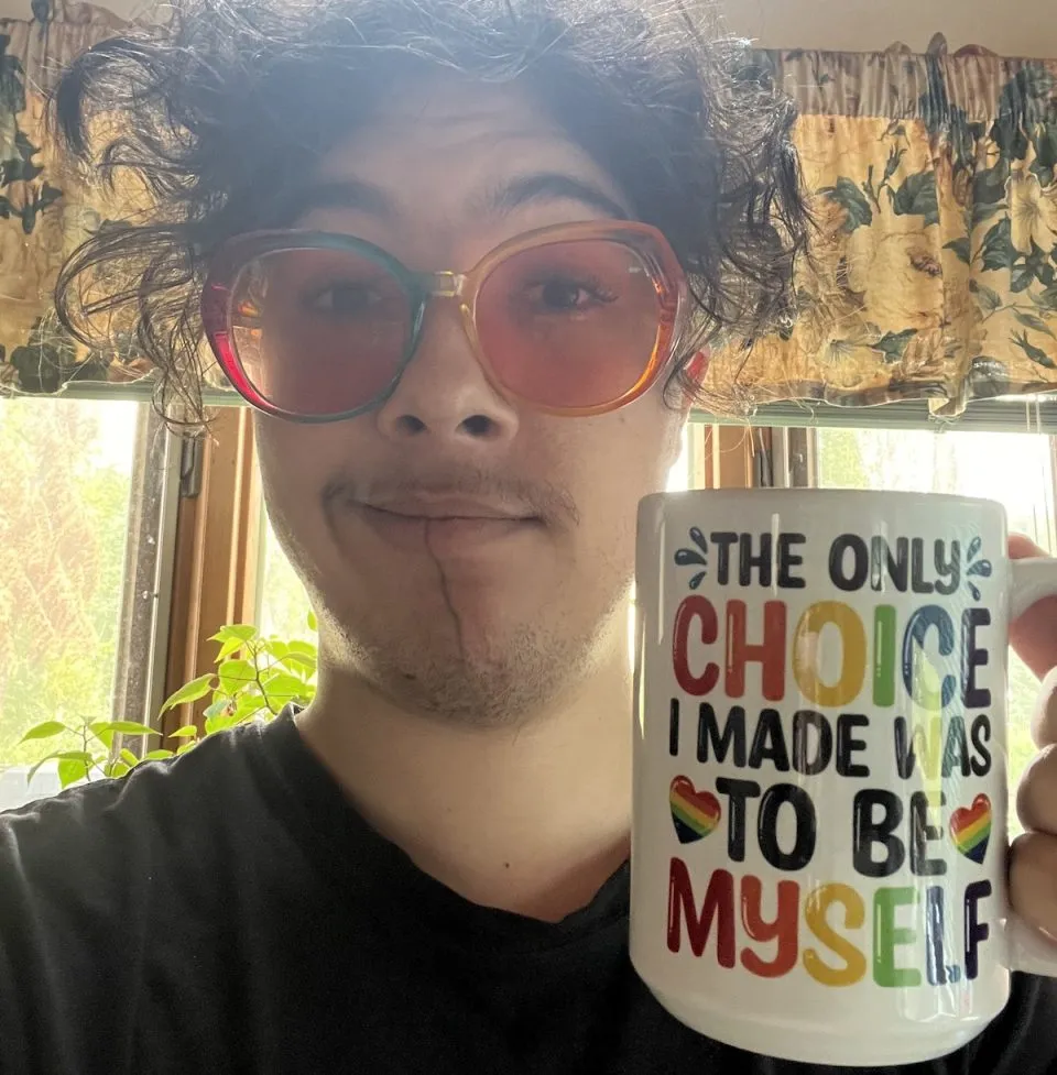 Cole Lawrence holding a mug that says "The only choice I made was to be myself." (Courtesy of Cole Lawrence)