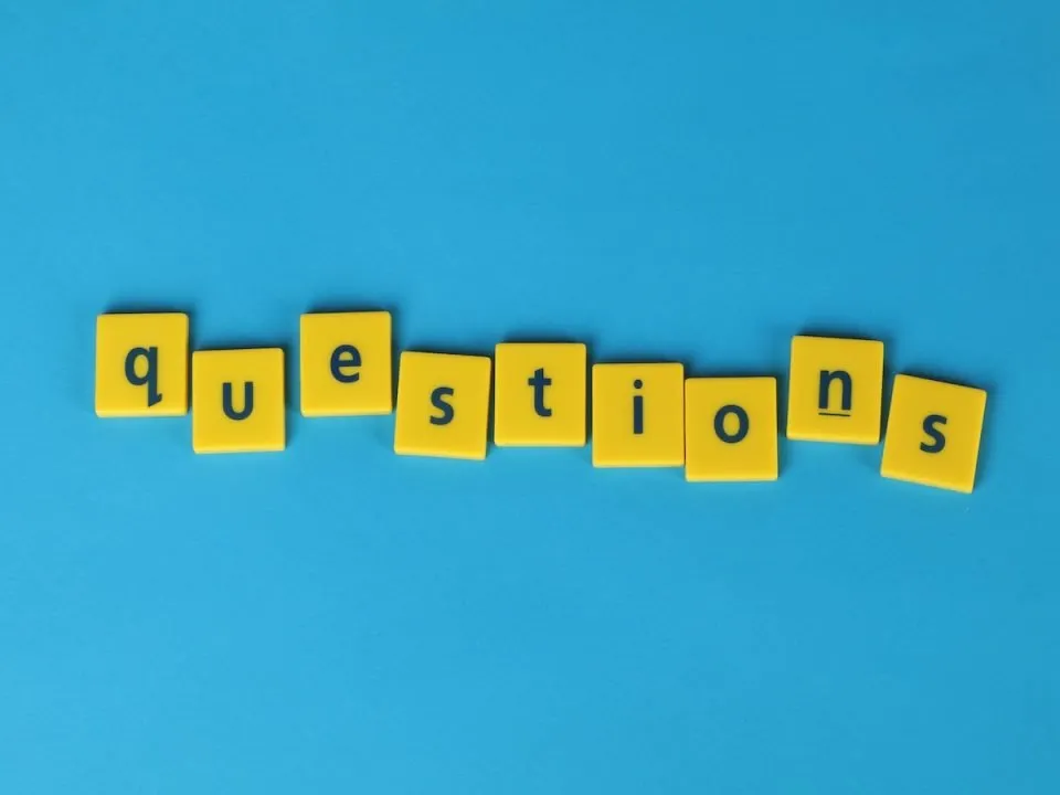 The word "questions" spelled by yellow lettered beads. (Pexels/Ann H)