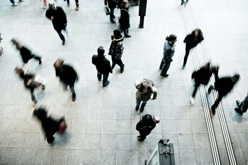 a crowd of people walking in different directions