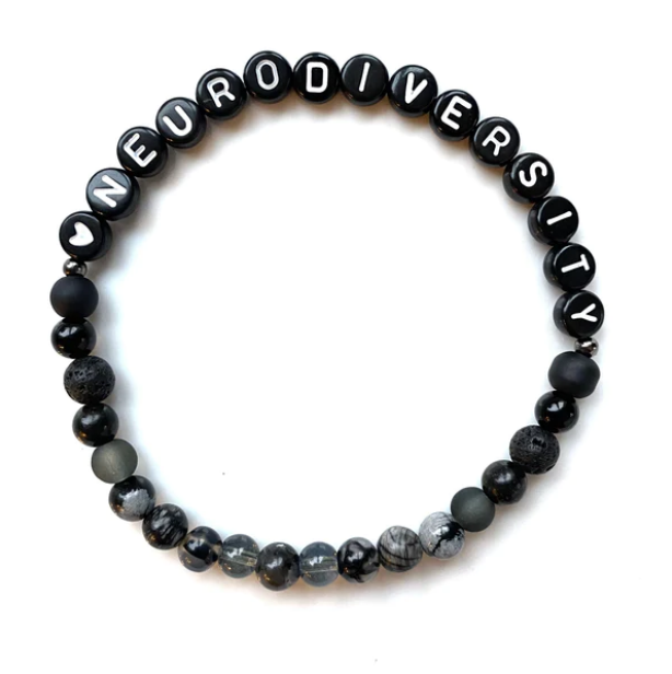 A black bracelet. Letter beads spell "neurodiversity"