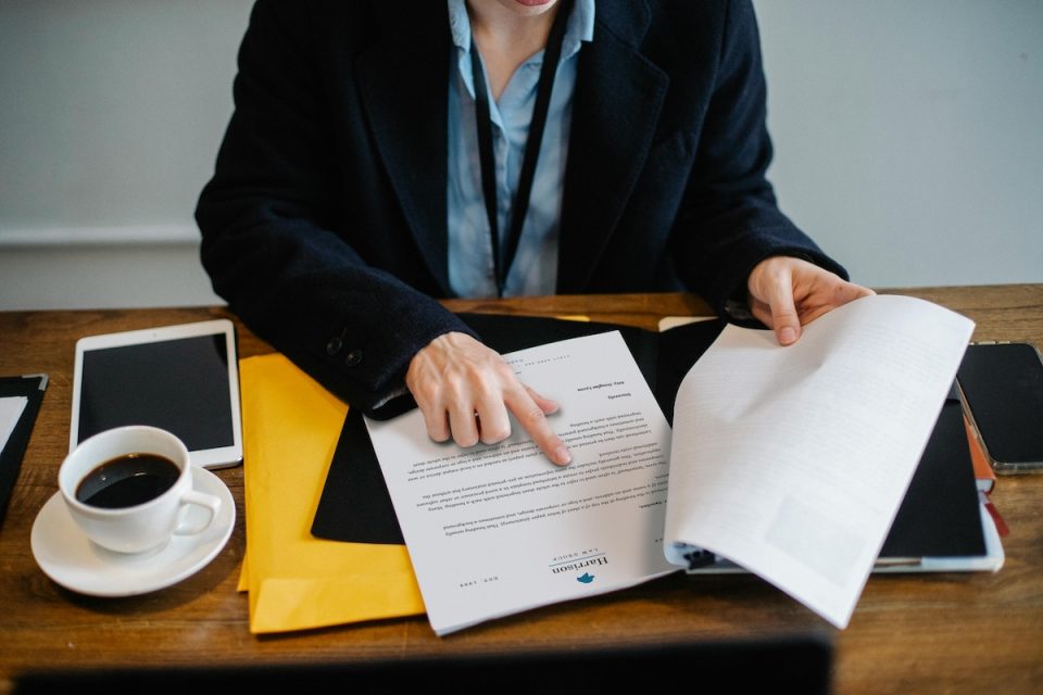 A person pointing to notes over coffee. (Pexels/Sora Shimazaki)