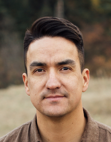A portrait photo of Grant Bruno, an Indigenous expert on neurodivergence. Grant is smiling, wearing a brown collared shirt, and looking at the camera.