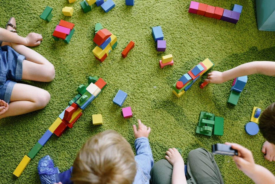 Children playing with wooden blocks. (Pexels/Ksenia Chernaya)