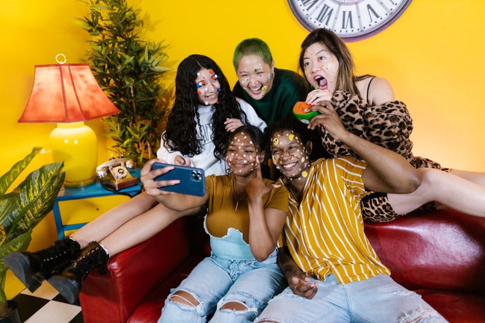 Teens wearing face stickers taking a selfie together. (RDNE Stock Project/Pexels)