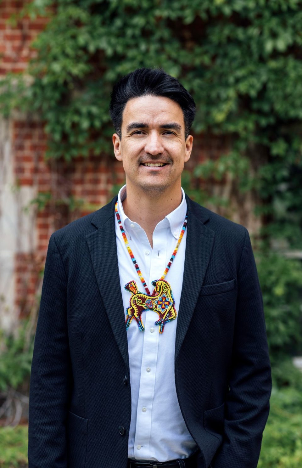 A photo of Dr. Grant Bruno standing outside and smiling.